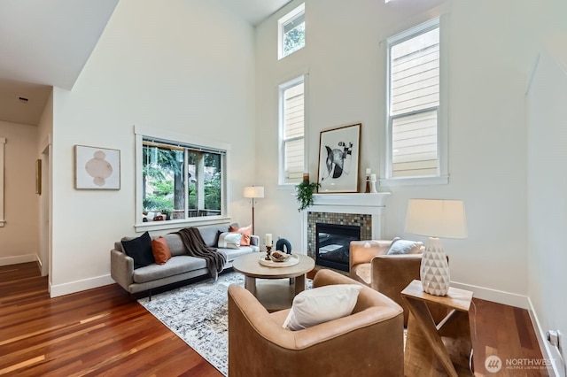 9064 177th Pl NE, Redmond, WA 98052 - living area with a high ceiling, dark wood-style flooring, and a brick fireplace