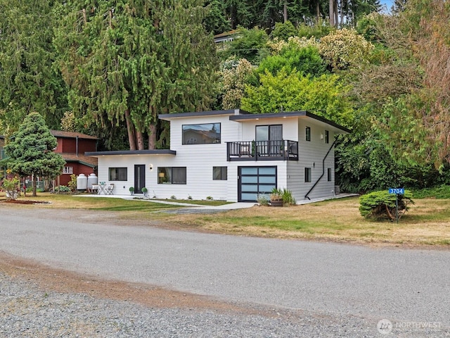 3704 Bells Ln, Langley, WA 98260 - contemporary house featuring driveway, a front yard, and a garage