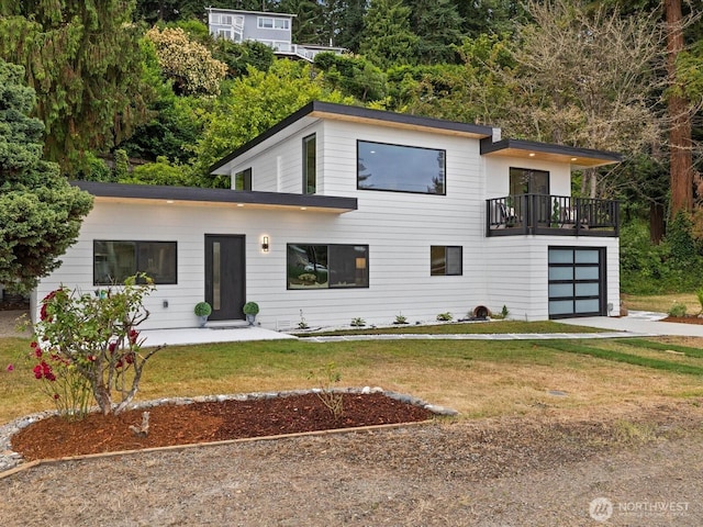 3704 Bells Ln, Langley, WA 98260 - contemporary home featuring a balcony, a front yard, driveway, and an attached garage