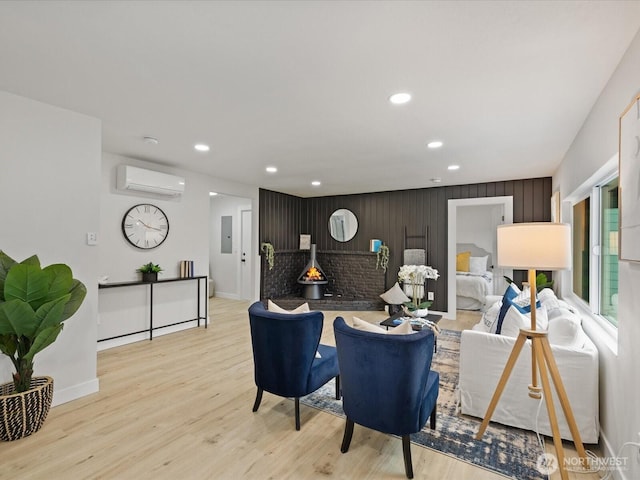 3704 Bells Ln, Langley, WA 98260 - living area with a wall mounted AC, electric panel, recessed lighting, light wood-style flooring, and an accent wall