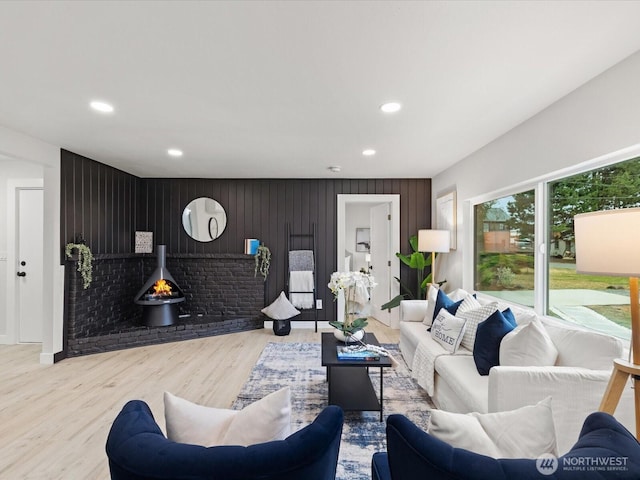 3704 Bells Ln, Langley, WA 98260 - living room with recessed lighting, wood finished floors, an accent wall, and wooden walls