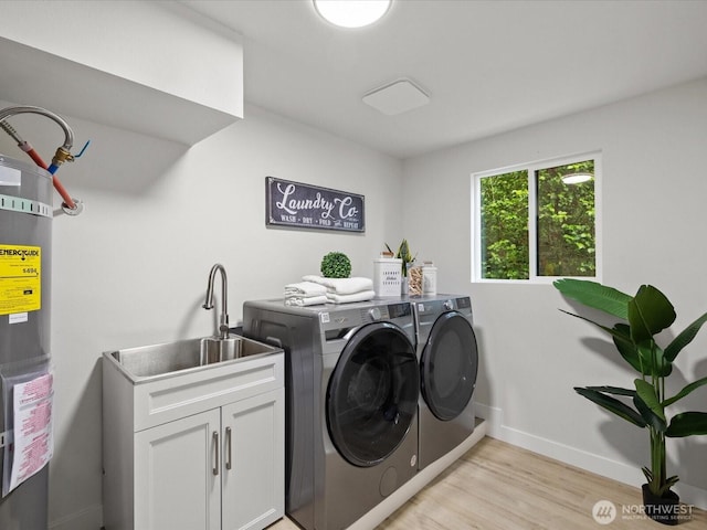 3704 Bells Ln, Langley, WA 98260 - laundry room with separate washer and dryer, cabinet space, light wood-style flooring, and water heater
