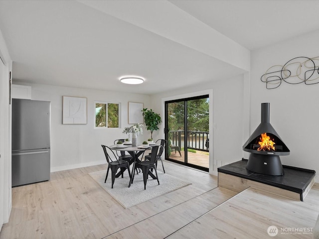 3704 Bells Ln, Langley, WA 98260 - dining area with a wood stove, plenty of natural light, and light wood-type flooring