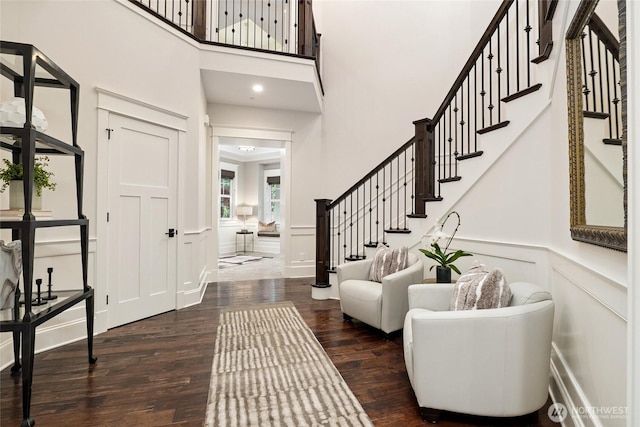 1709 223rd Ave SE, Sammamish, WA 98075 - entrance foyer with wood finished floors, stairs, a decorative wall, wainscoting, and a high ceiling