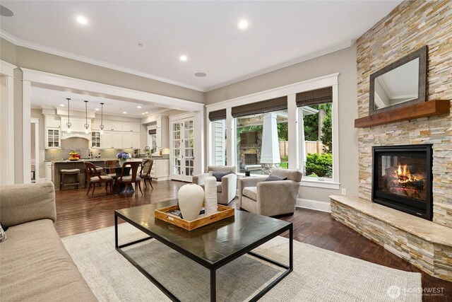 1709 223rd Ave SE, Sammamish, WA 98075 - living room featuring dark wood-style flooring, a fireplace, crown molding, and recessed lighting