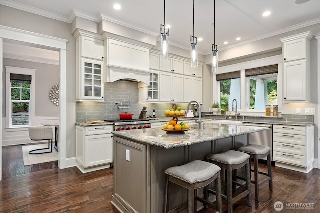 1709 223rd Ave SE, Sammamish, WA 98075 - kitchen with appliances with stainless steel finishes, a center island with sink, white cabinetry, recessed lighting, and ornamental molding