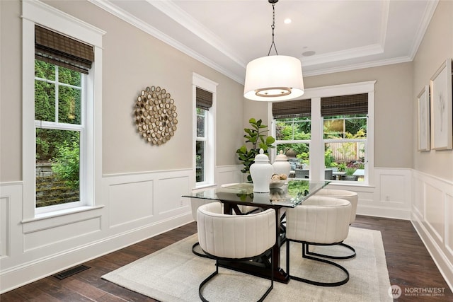 1709 223rd Ave SE, Sammamish, WA 98075 - dining space with dark wood-type flooring, a wainscoted wall, a decorative wall, crown molding, and a tray ceiling