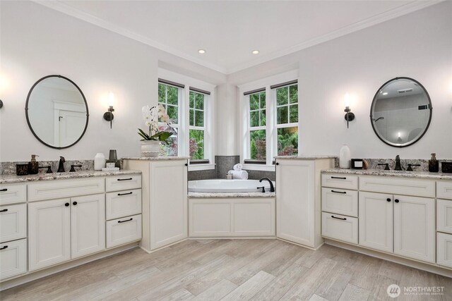 1709 223rd Ave SE, Sammamish, WA 98075 - full bath with two vanities, wood finished floors, ornamental molding, a bath, and recessed lighting