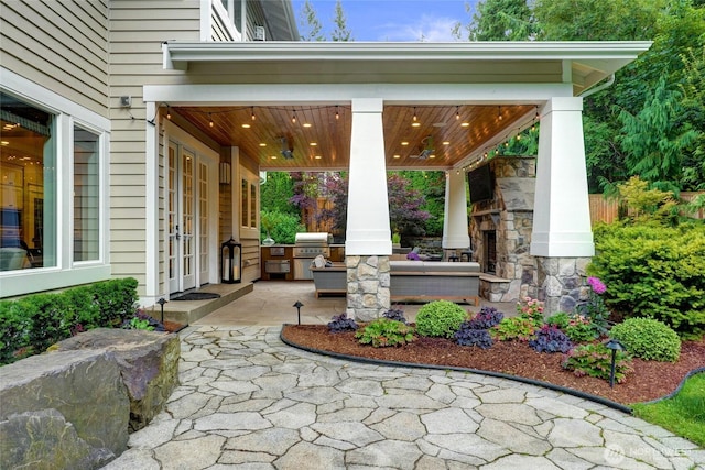 1709 223rd Ave SE, Sammamish, WA 98075 - view of patio / terrace featuring an outdoor stone fireplace and area for grilling