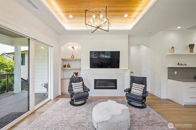 9051 Sea Mist Ln, Blaine, WA 98230 - living area featuring a tray ceiling, a high end fireplace, light wood-type flooring, built in features, and recessed lighting