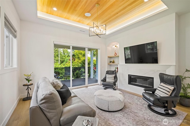 9051 Sea Mist Ln, Blaine, WA 98230 - living room featuring a tray ceiling, built in shelves, wood finished floors, recessed lighting, and wood ceiling