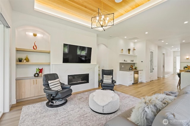 9051 Sea Mist Ln, Blaine, WA 98230 - living room with a bar, light wood-type flooring, a premium fireplace, built in shelves, and recessed lighting