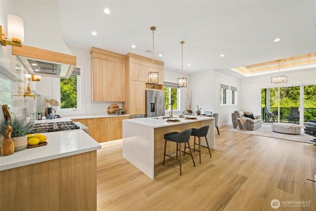 9051 Sea Mist Ln, Blaine, WA 98230 - kitchen featuring stainless steel refrigerator with ice dispenser, light brown cabinets, light wood finished floors, modern cabinets, and open floor plan