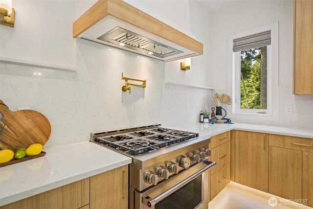 9051 Sea Mist Ln, Blaine, WA 98230 - kitchen featuring high end stainless steel range oven, extractor fan, modern cabinets, and light stone countertops