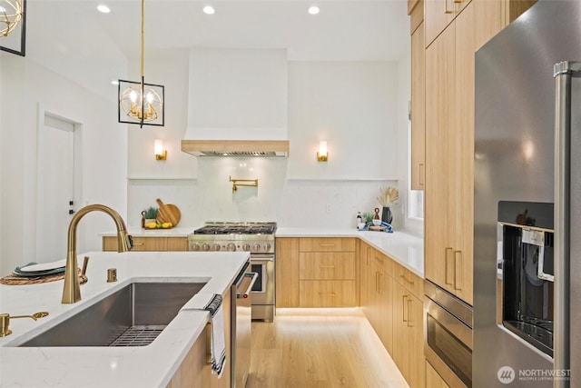 9051 Sea Mist Ln, Blaine, WA 98230 - kitchen featuring stainless steel appliances, modern cabinets, light brown cabinetry, recessed lighting, and a chandelier