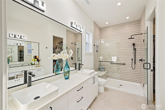 9051 Sea Mist Ln, Blaine, WA 98230 - bathroom with a walk in closet, a shower stall, double vanity, and recessed lighting