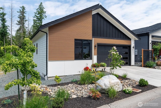 9051 Sea Mist Ln, Blaine, WA 98230 - modern home with driveway, a garage, and board and batten siding