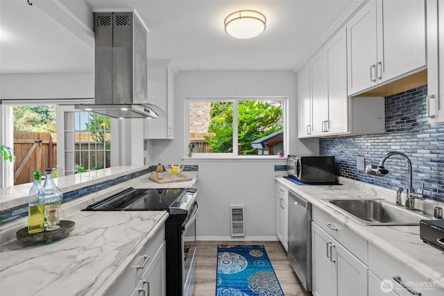 12240 SE 60th St Unit 41, Bellevue, WA 98006 - kitchen with appliances with stainless steel finishes, exhaust hood, light wood-style floors, tasteful backsplash, and white cabinets