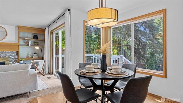 12607 SE 255th Pl, Kent, WA 98030 - dining room with wood finished floors and a brick fireplace