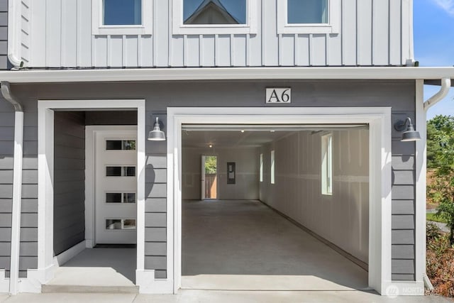 15726 40th Ave W Unit A6, Lynnwood, WA 98087 - doorway to property with board and batten siding and a garage