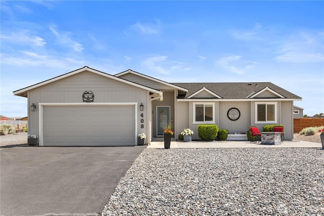 409 Davidson Blvd SW, Mattawa, WA 99349 - ranch-style home featuring asphalt driveway, an attached garage, and a shingled roof