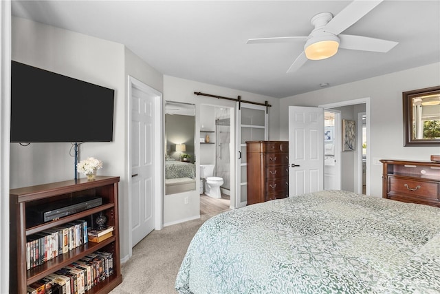 409 Davidson Blvd SW, Mattawa, WA 99349 - bedroom featuring a barn door, carpet floors, connected bathroom, and ceiling fan