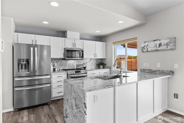409 Davidson Blvd SW, Mattawa, WA 99349 - kitchen featuring stainless steel appliances, a peninsula, white cabinets, dark wood-style flooring, and recessed lighting