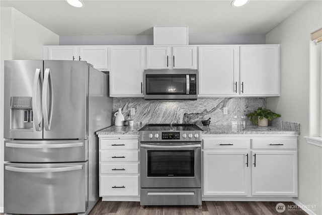 409 Davidson Blvd SW, Mattawa, WA 99349 - kitchen featuring appliances with stainless steel finishes, white cabinets, dark wood-style floors, tasteful backsplash, and recessed lighting