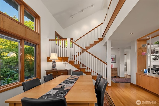 2337 NW 194th Pl, Shoreline, WA 98177 - dining space with a high ceiling, stairs, light wood-type flooring, and track lighting