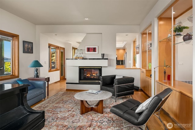 2337 NW 194th Pl, Shoreline, WA 98177 - living room with wood finished floors, a multi sided fireplace, and recessed lighting