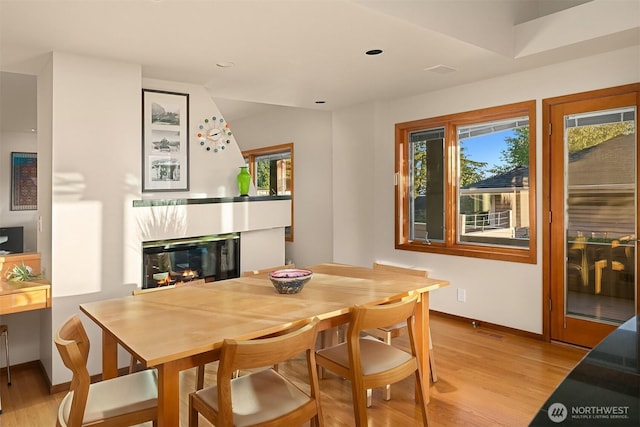 2337 NW 194th Pl, Shoreline, WA 98177 - dining room featuring a glass covered fireplace, plenty of natural light, light wood-type flooring, and recessed lighting