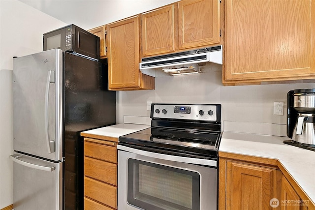 1810 S Tyler St, Tacoma, WA 98405 - kitchen featuring appliances with stainless steel finishes, under cabinet range hood, and light countertops