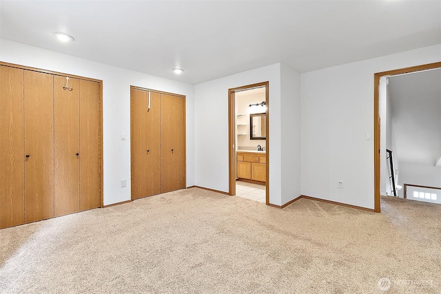 1810 S Tyler St, Tacoma, WA 98405 - unfurnished bedroom featuring two closets, light carpet, and connected bathroom