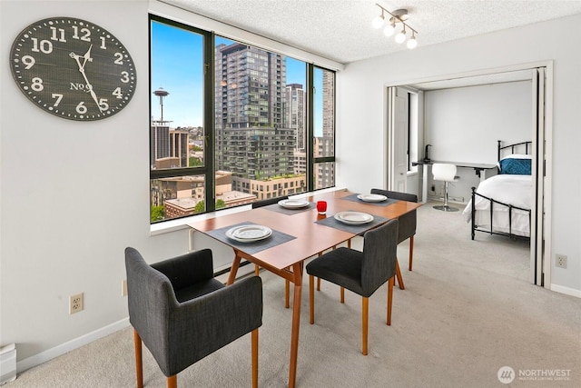 2201 3rd Ave Unit 1404, Seattle, WA 98121 - carpeted dining area with expansive windows, a city view, a textured ceiling, and track lighting