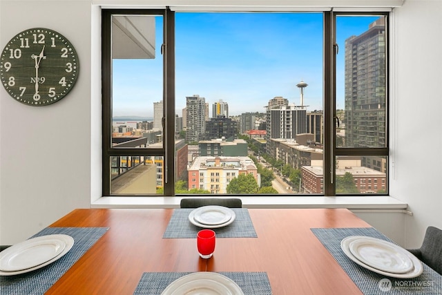 2201 3rd Ave Unit 1404, Seattle, WA 98121 - dining space with wood finished floors, a view of city, and a wall of windows