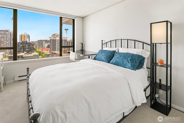 2201 3rd Ave Unit 1404, Seattle, WA 98121 - bedroom featuring carpet flooring, a city view, multiple windows, and a textured ceiling