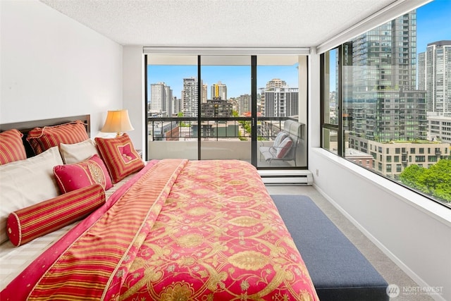 2201 3rd Ave Unit 1404, Seattle, WA 98121 - carpeted bedroom with a view of skyline, access to outside, a textured ceiling, and multiple windows