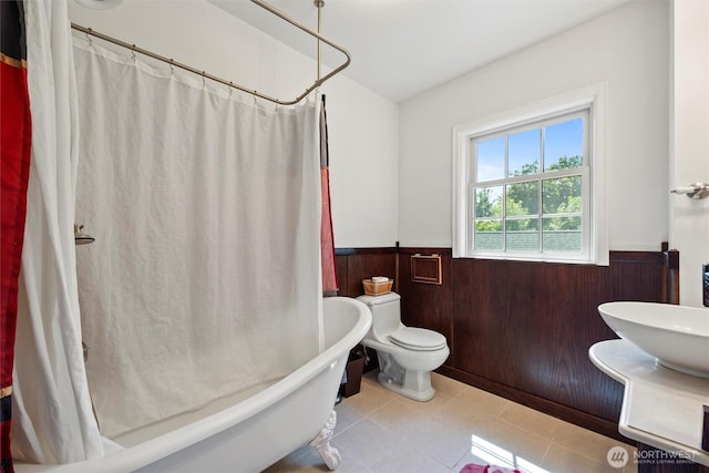 444 Washington St, Walla Walla, WA 99362 - full bath with wainscoting, tile patterned flooring, shower / bathtub combination with curtain, and wood walls