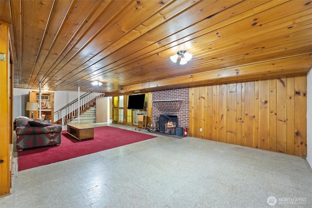 444 Washington St, Walla Walla, WA 99362 - unfurnished living room with stairway, a brick fireplace, wood ceiling, wood walls, and tile patterned floors
