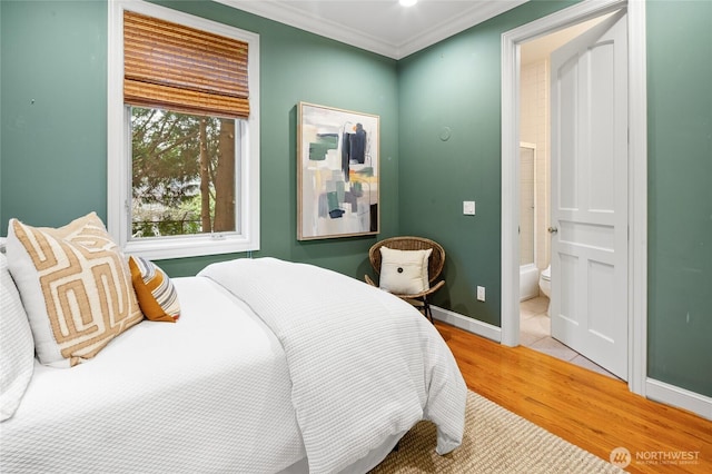 1510 38th Ave E, Seattle, WA 98112 - bedroom featuring light wood-style floors, crown molding, and ensuite bath