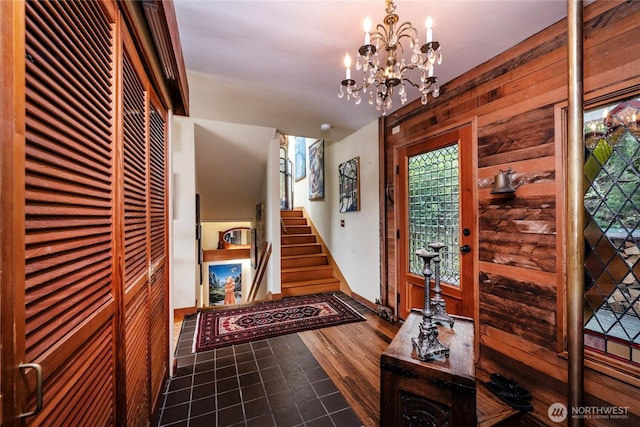 4722 53rd Ave SW, Seattle, WA 98116 - foyer entrance featuring a chandelier, stairs, wood walls, and dark wood-type flooring