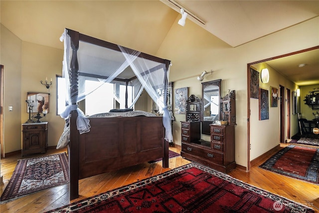 4722 53rd Ave SW, Seattle, WA 98116 - bedroom with hardwood / wood-style flooring, lofted ceiling, and rail lighting