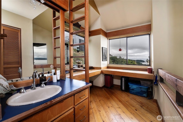 4722 53rd Ave SW, Seattle, WA 98116 - bathroom with vanity, hardwood / wood-style flooring, and vaulted ceiling