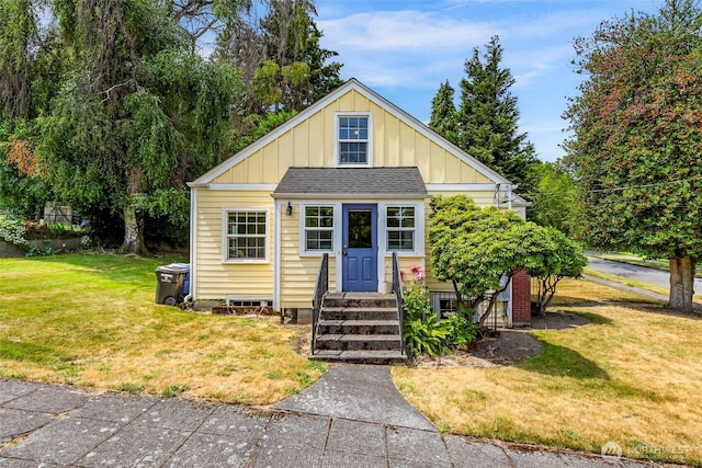 403 W Dravus St, Seattle, WA 98119 - view of front of house featuring board and batten siding, a front lawn, roof with shingles, and entry steps
