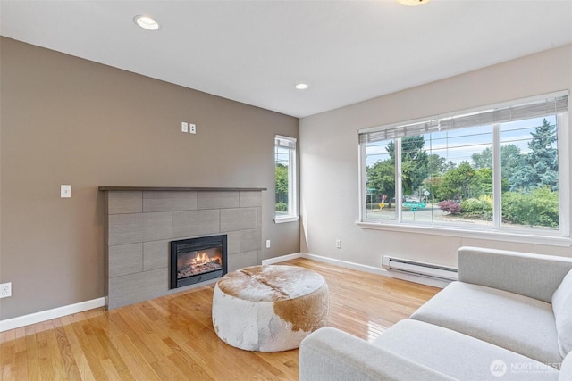 3017 Government Way, Seattle, WA 98199 - living area with baseboard heating, wood finished floors, a tile fireplace, and recessed lighting
