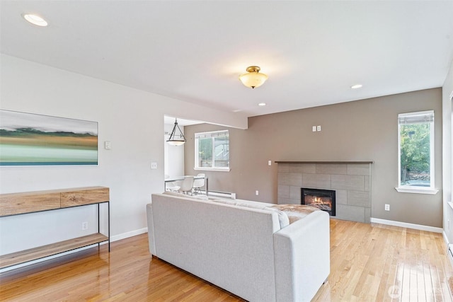 3017 Government Way, Seattle, WA 98199 - living room with light wood finished floors, healthy amount of natural light, a tiled fireplace, and recessed lighting
