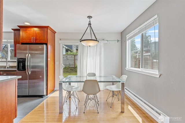 3017 Government Way, Seattle, WA 98199 - dining space with a baseboard heating unit, healthy amount of natural light, and light wood finished floors