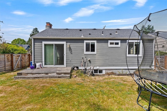 3017 Government Way, Seattle, WA 98199 - rear view of property featuring a fenced backyard, a chimney, a patio area, and a trampoline