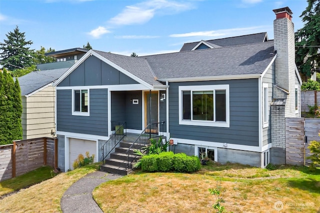 3017 Government Way, Seattle, WA 98199 - view of front of home featuring an attached garage, a chimney, a shingled roof, and board and batten siding