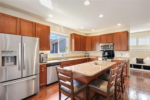 33908 12th Pl SW, Federal Way, WA 98023 - kitchen featuring stainless steel appliances, dark wood-style flooring, a breakfast bar area, light stone counters, and recessed lighting